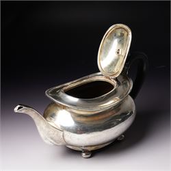 Silver tea pot of oval form with ebonised handle and lift on compressed bun feet Sheffield 1919 Maker Atkin Bros.