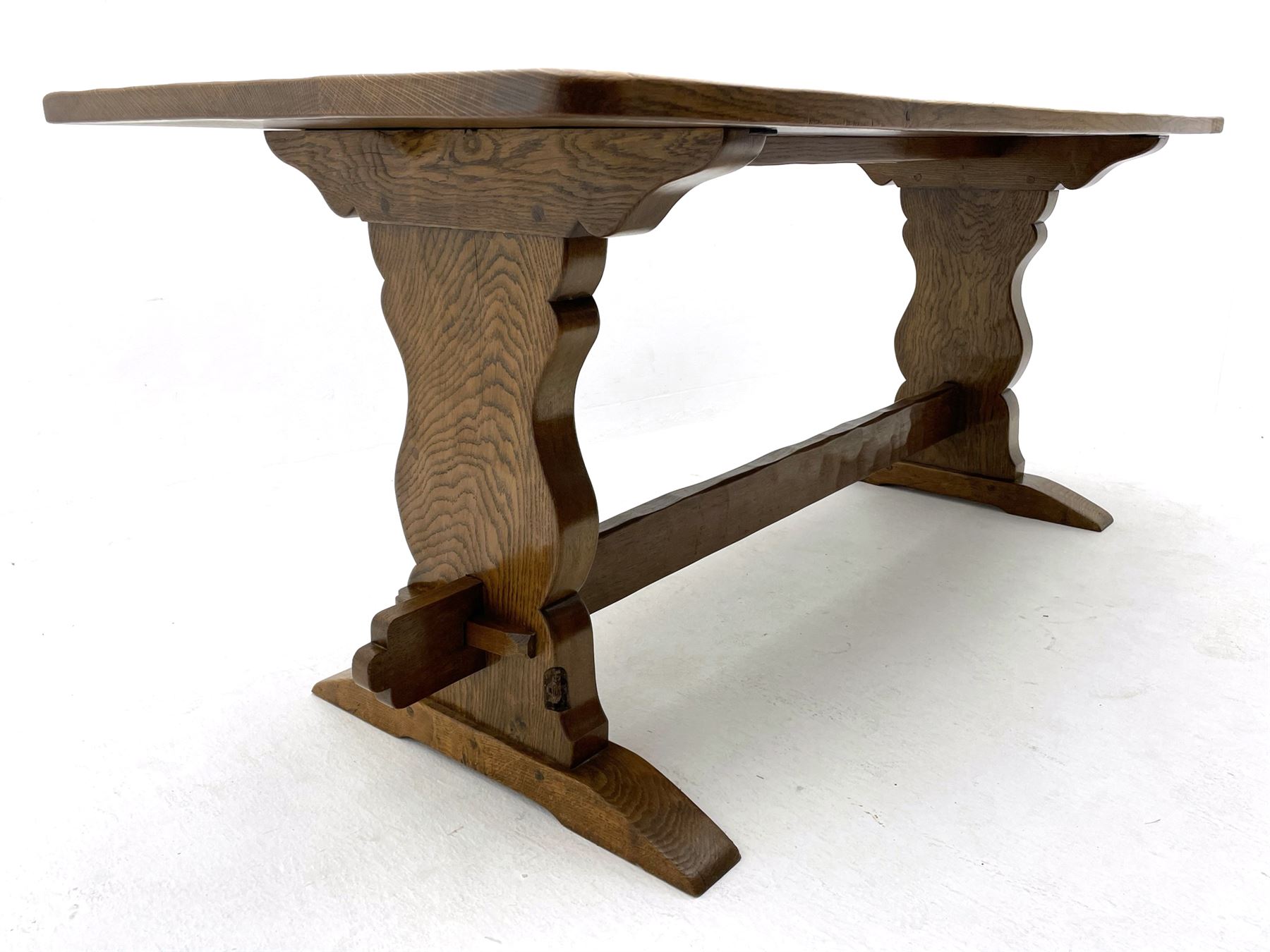 ‘Gnomeman’ oak dining table, rectangular adzed top, shaped end supports on sledge feet joined by pegged stretcher, carved with gnome signature, by Thomas Whittaker of Littlebeck
