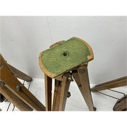Three wooden adjustable tripods for plate cameras, together with a Linhof of Munchen metal tripod in a canvas case 