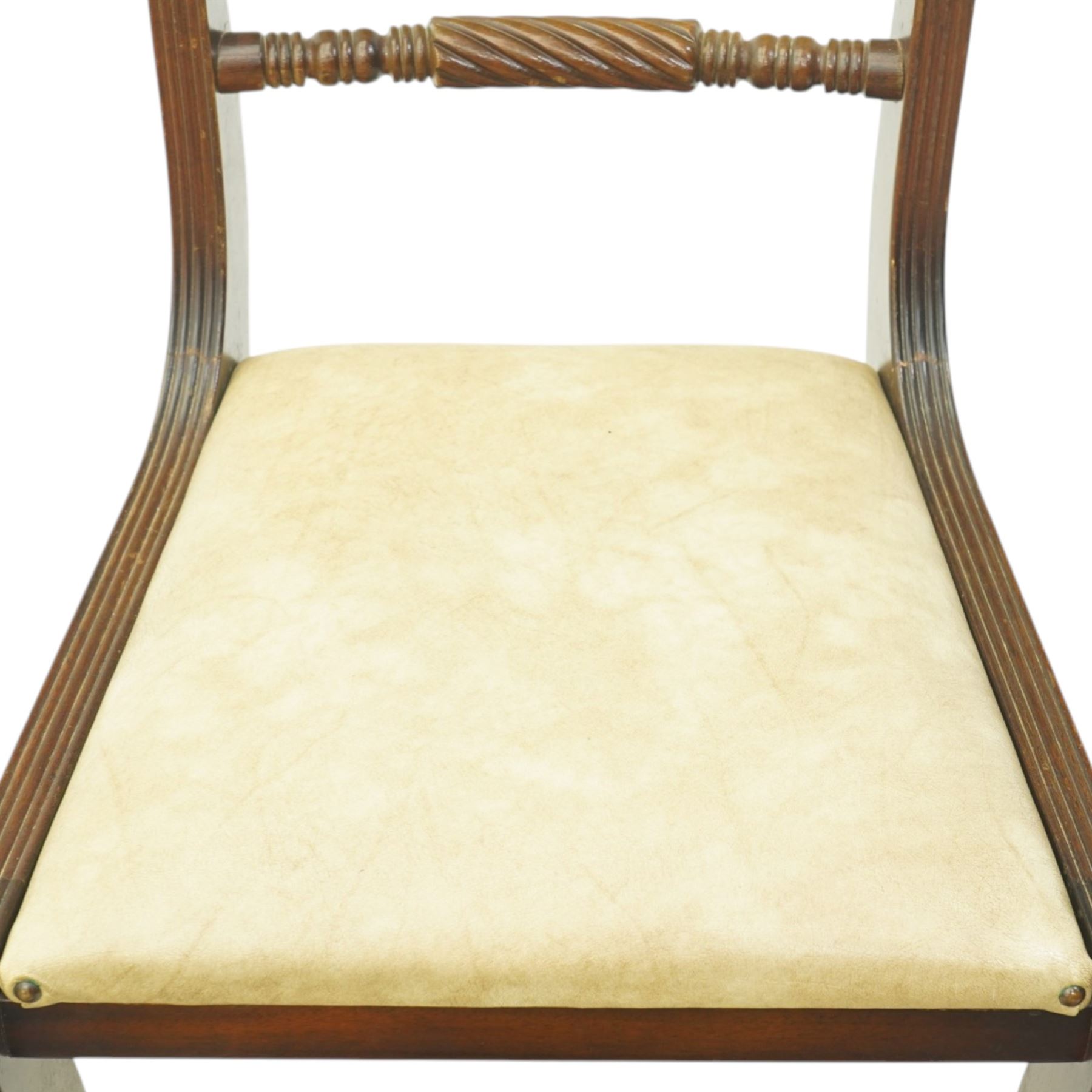 Late 20th century Regency style mahogany dining chairs, set of four, bar backs with figured veneered top rails and turned spindle stretchers, drop-in seats upholstered in beige leather, on moulded sabre supports