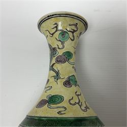 20th century Chinese Famille Verte vase, of slender ovoid form with tapering neck and flared rim, decorated with green and grey enamel with dragons chasing flaming pearls amongst auspicious clouds upon a yellow ground, H30cm
