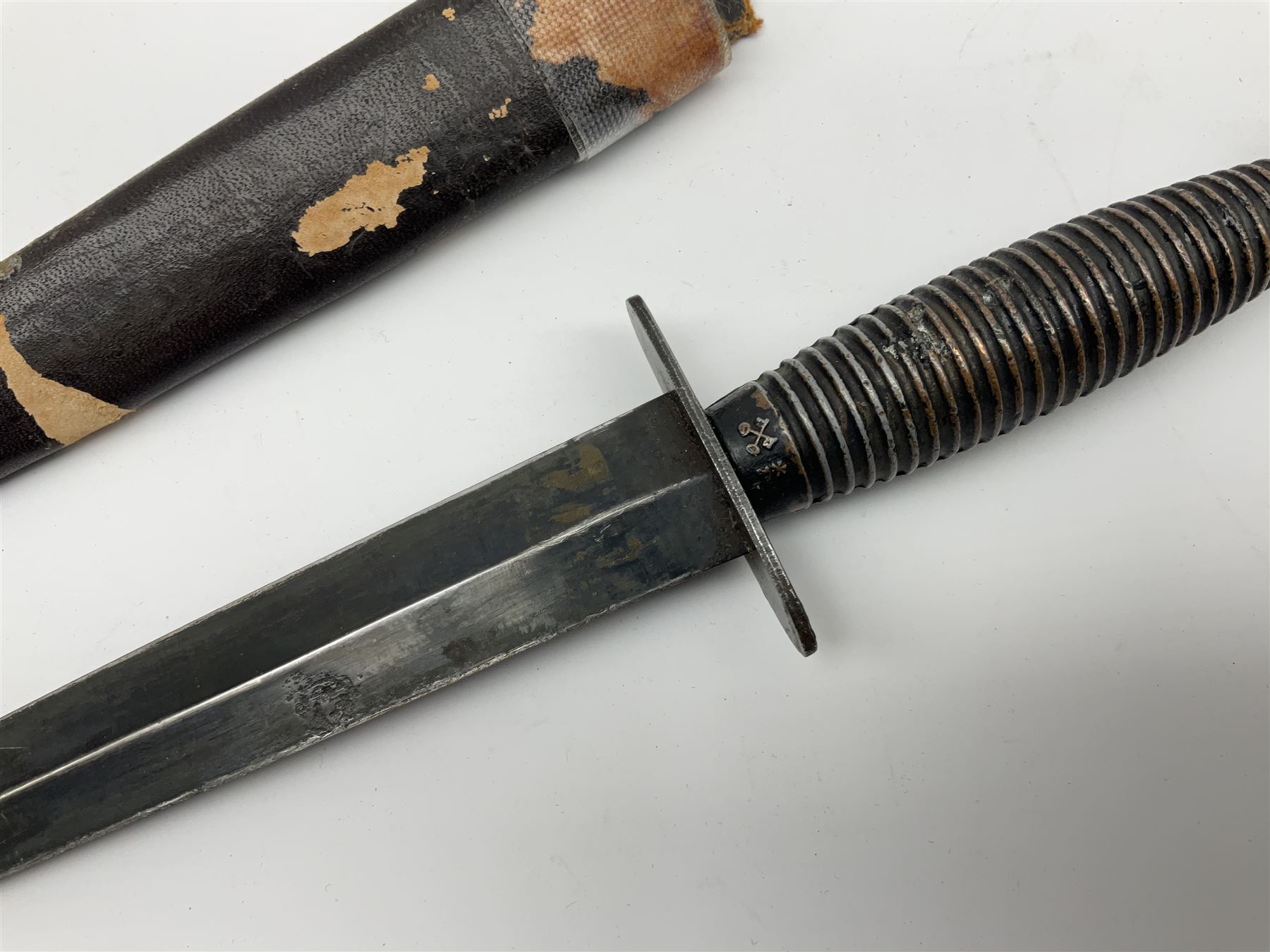 Post WW2 Fairbairn Sykes style black commando knife, no makers name but the handle marked with 'crossed keys *A' L30cm, in part scabbard