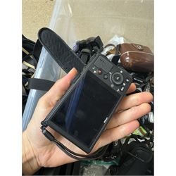 Collection of cameras and camera equipment, including Voigtlander Vitomatic I, Nikon Coolpix P340, Nikon Coolpix S9100, Olympus SP-510UZ, tripod, cases, etc