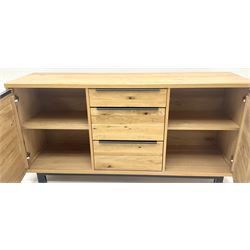 Oak sideboard, one shallow and two deep drawers, flanked by two cupboards revealing fitted interior, metal framed supports 