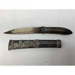 Burmese dha dagger with 15cm steel blade, white metal ferrule and horn handle, in white metal and filigree scabbard L30.5cm; a Burmese long bladed knife with horn handle and brass mounted teak scabbard; and another Eastern dagger in sheath (3)