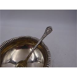 Early 20th century silver open sucrier, of circular form, with fluted gadrooned rim and decorated in relief with floral swags, united by three lion mask mounts and upon three paw feet, hallmarked Z Barraclough & Sons, London 1912, H6cm, D11cm, with similar spoon with lion mask finial, hallmarked London 1912, maker's mark indistinct
