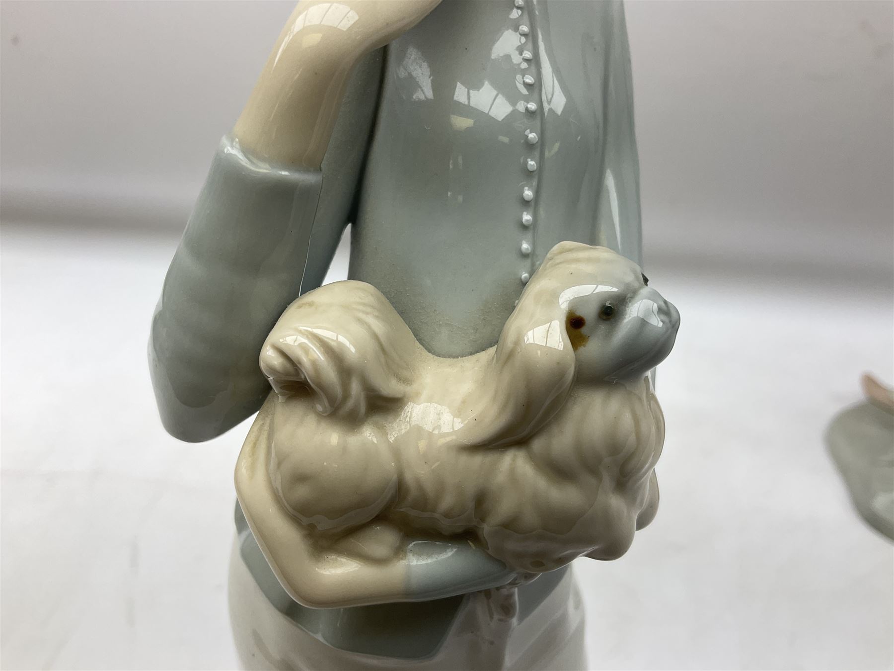 Lladro 'Walk With the Dog' figure no. 4893, together with Lladro swan figure, Porceval figure of a gentleman with a bird perched upon his hand and a further of a lady with flowers beside a basket, all with marks beneath, tallest H40cm