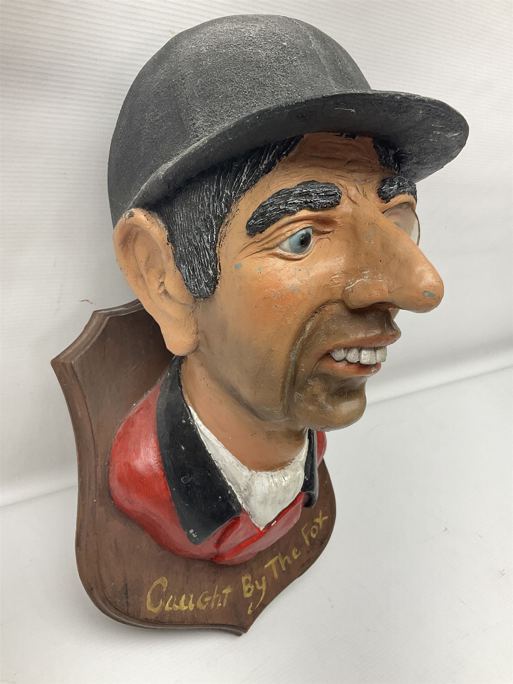 Composite figure of the head of a huntsman on a shield 'Caught by the Fox', D28cm