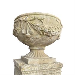 Pair of quality Neoclassical design Haddonstone cast stone garden urns, the globular  body decorated with relief foliate festoons and fruiting motifs, over a fluted socle, the rectangular pedestals with relief foliate wreaths and ribbon garlands