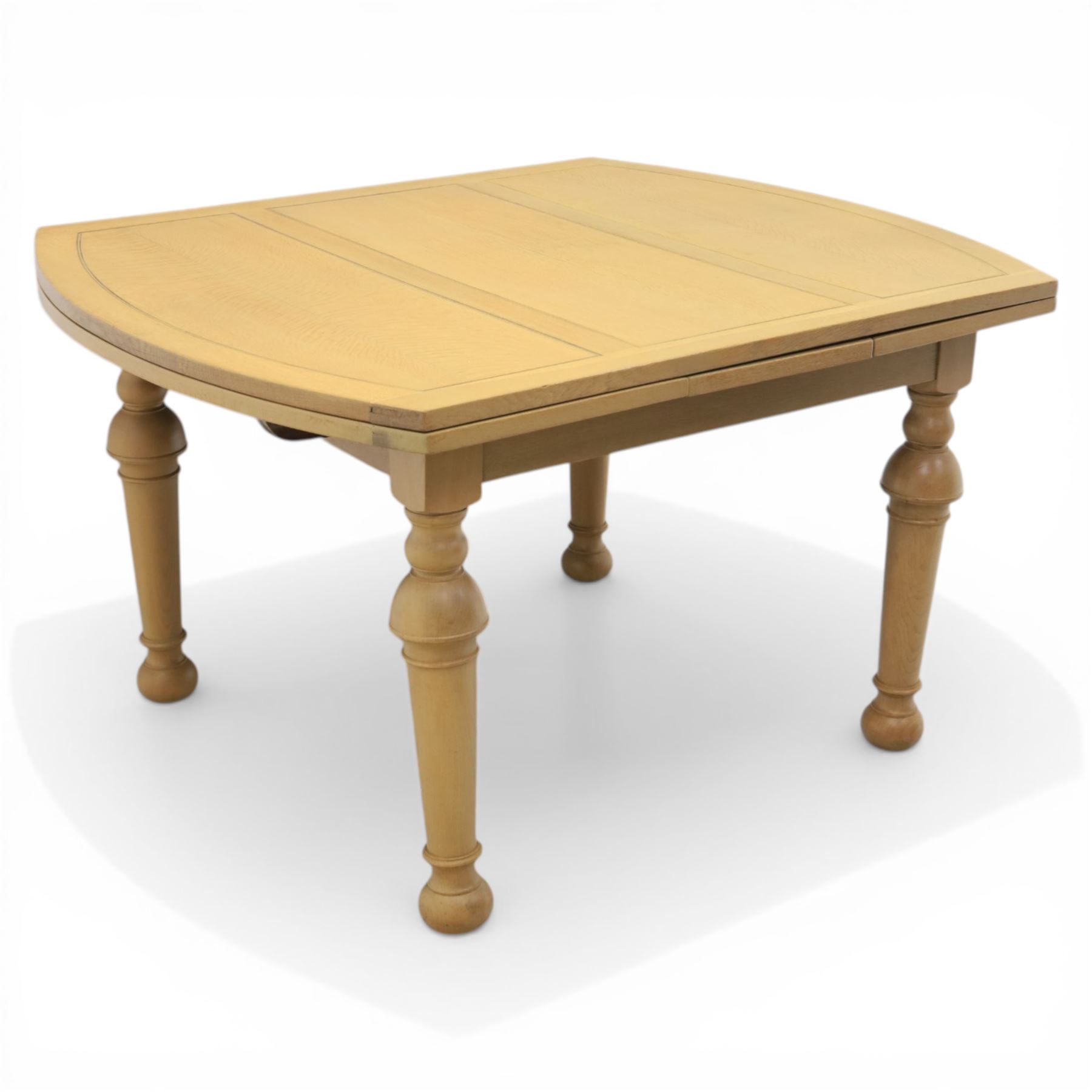 Edwardian light oak extending dining table, oval-ended rectangular top with panelled decoration and double line borders, draw-leaf extension action to 211cm long, on turned supports