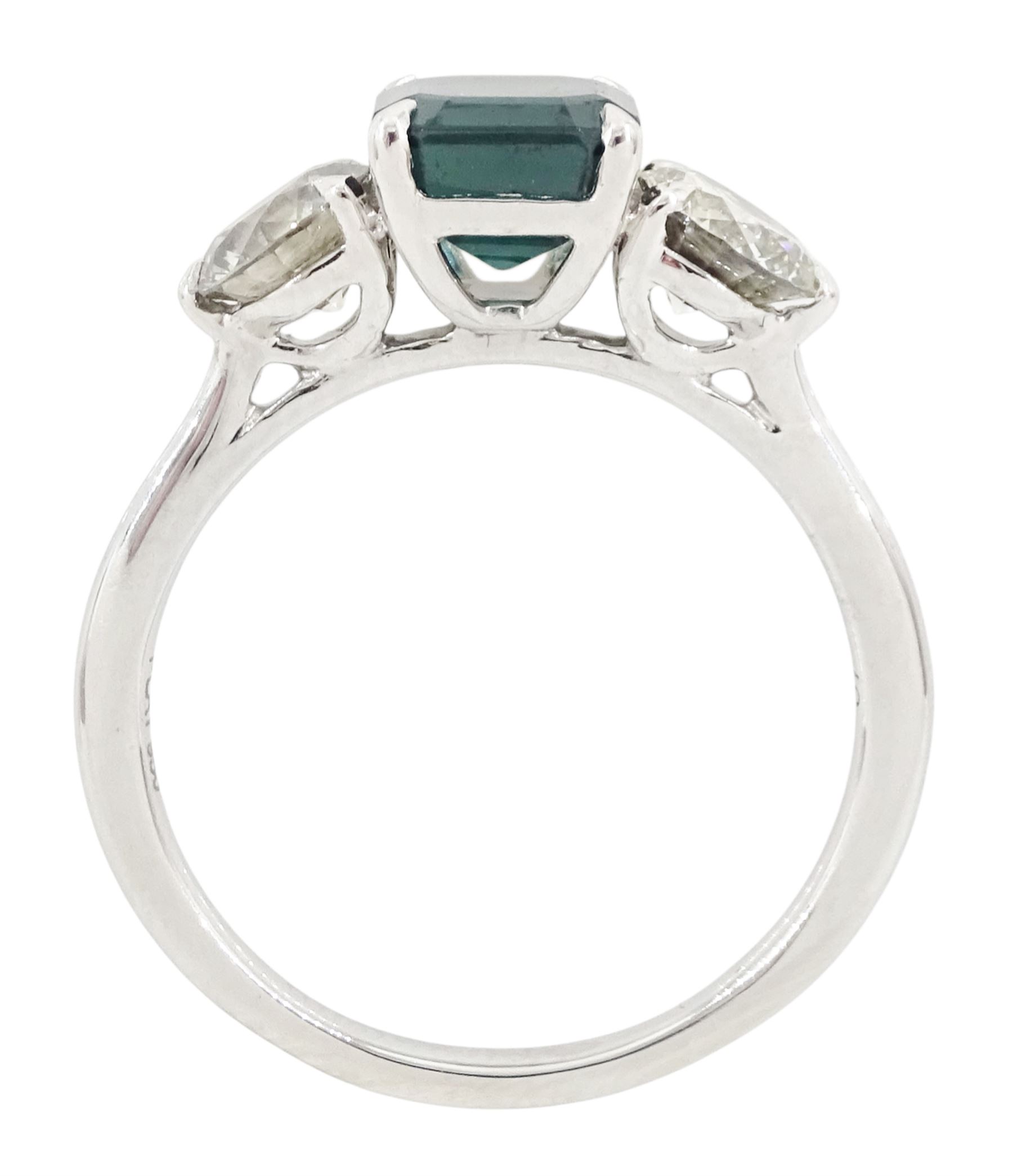Platinum tourmaline and diamond three stone ring, single octagonal cut green tourmaline of approx 1.65 carat, with a round brilliant cut diamond set either side, stamped PT 950, total diamond weight approx 1.05 carat