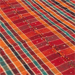 South West Persian Jajim kilim, formed from two joined flatwoven panels, patterned with intersecting stripes in red, orange, green, dark brown and ivory forming a checked design, scattered coloured dot motifs, multicoloured wool tassels along the sides