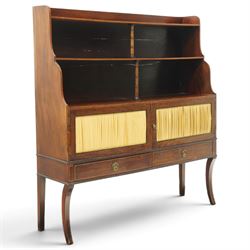 Regency period mahogany waterfall-bookcase chiffonier, the raised back with two open shelves supported by central ring-turned pilasters, fitted with twin doors with sage-green pleated fabric facias, over two drawers with satinwood stringing, raised on front sabre supports