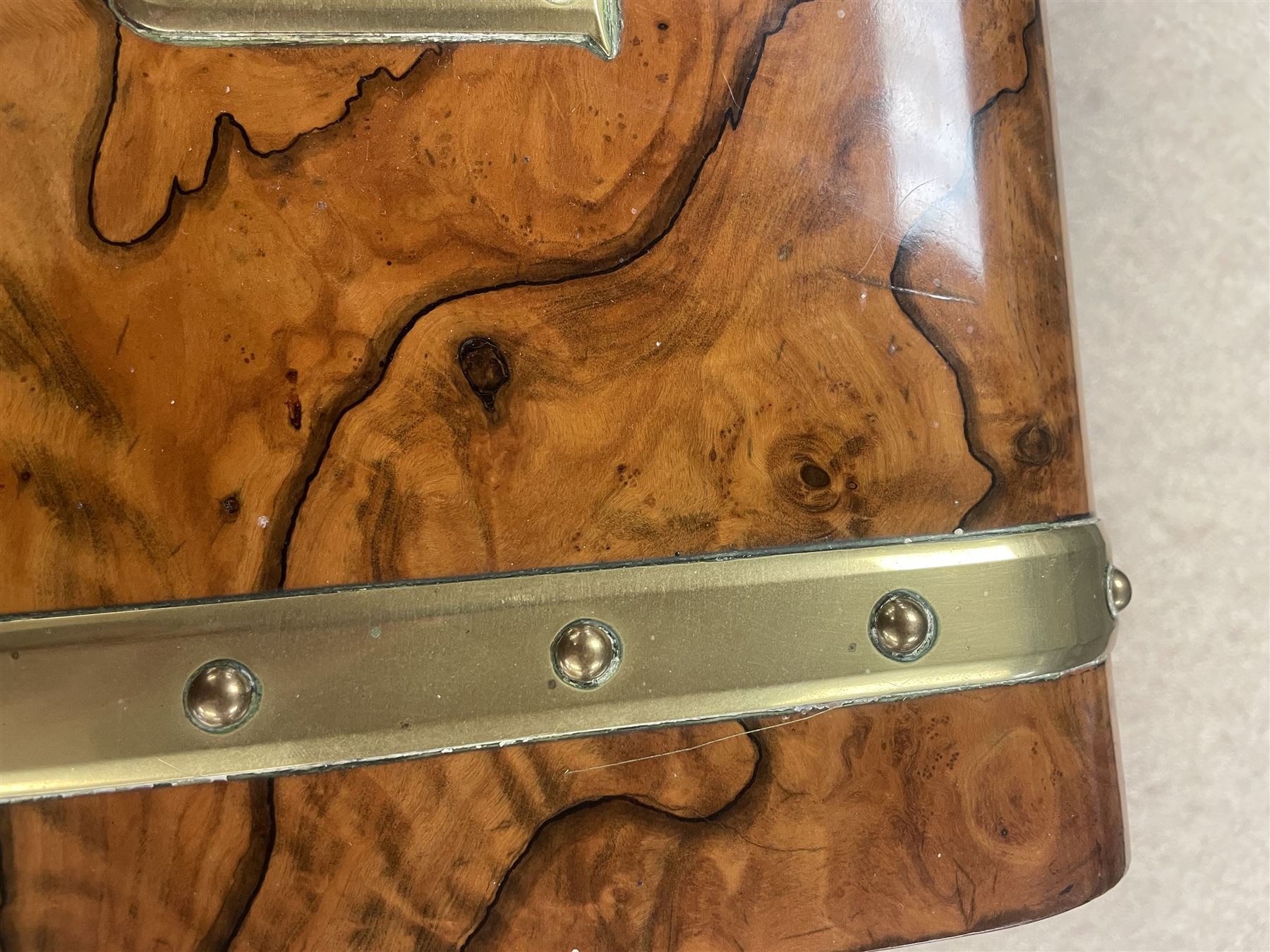 19th century walnut and brass bound games compendium box, painted to enhance the grain, of rectangular form, the hinged opening cover with rounded sides, central brass cartouche with engraved lion crest, and brass riveted straps, opening to reveal a red leather and blue silk lined compartmented interior, with fold-down games board, and lift-out tray containing playing cards, ebony turned dice towers, white and red stained bone draughts, and chess pieces, ivory dice, and ivory and ebony whist markers, and brass bezique board, cribbage board and markers, H15cm W32cm D24cm
This lot has been registered for sale under Section 10 of the APHA Ivory Act