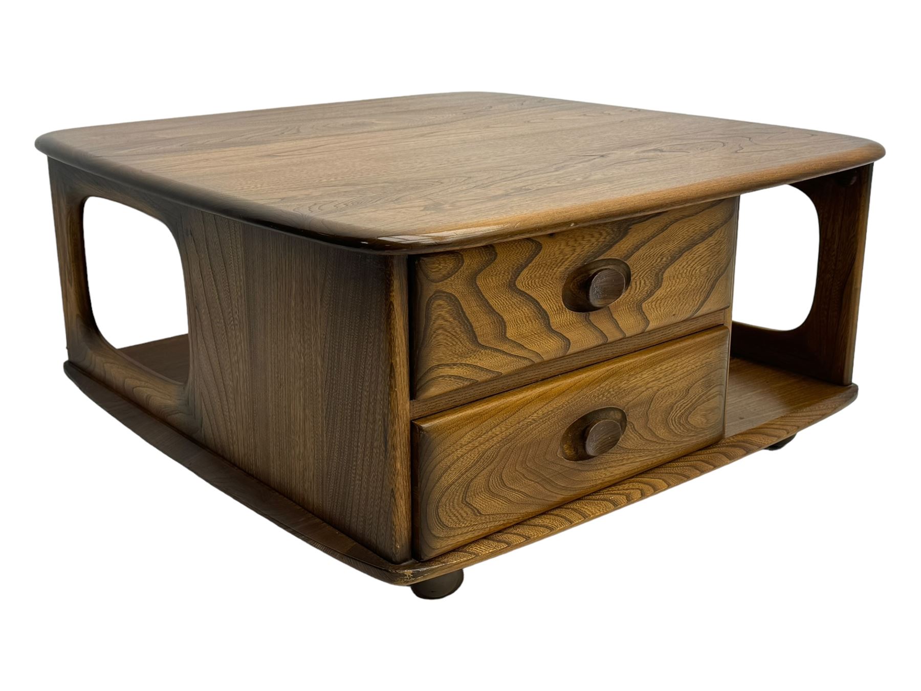 Lucian Ercolani for Ercol - elm 'Pandora's Box' coffee table, square top with rounded corners over two drawers with sculpted recessed pulls, open sides supporting undertier, on castors 