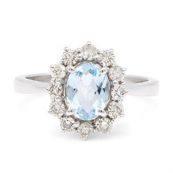 18ct white gold aquamarine and diamond cluster ring, single oval cut aquamarine of approx ...