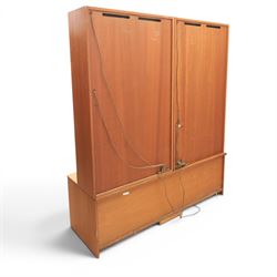 G-Plan - Mid 20th century teak modular wall unit, the upper section fitted with twin glazed doors enclosing shelves, adjoining concertina doors with mirrored and shelved interior, the base with four cupboard doors with recessed rectangular handles, raised on a plinth base