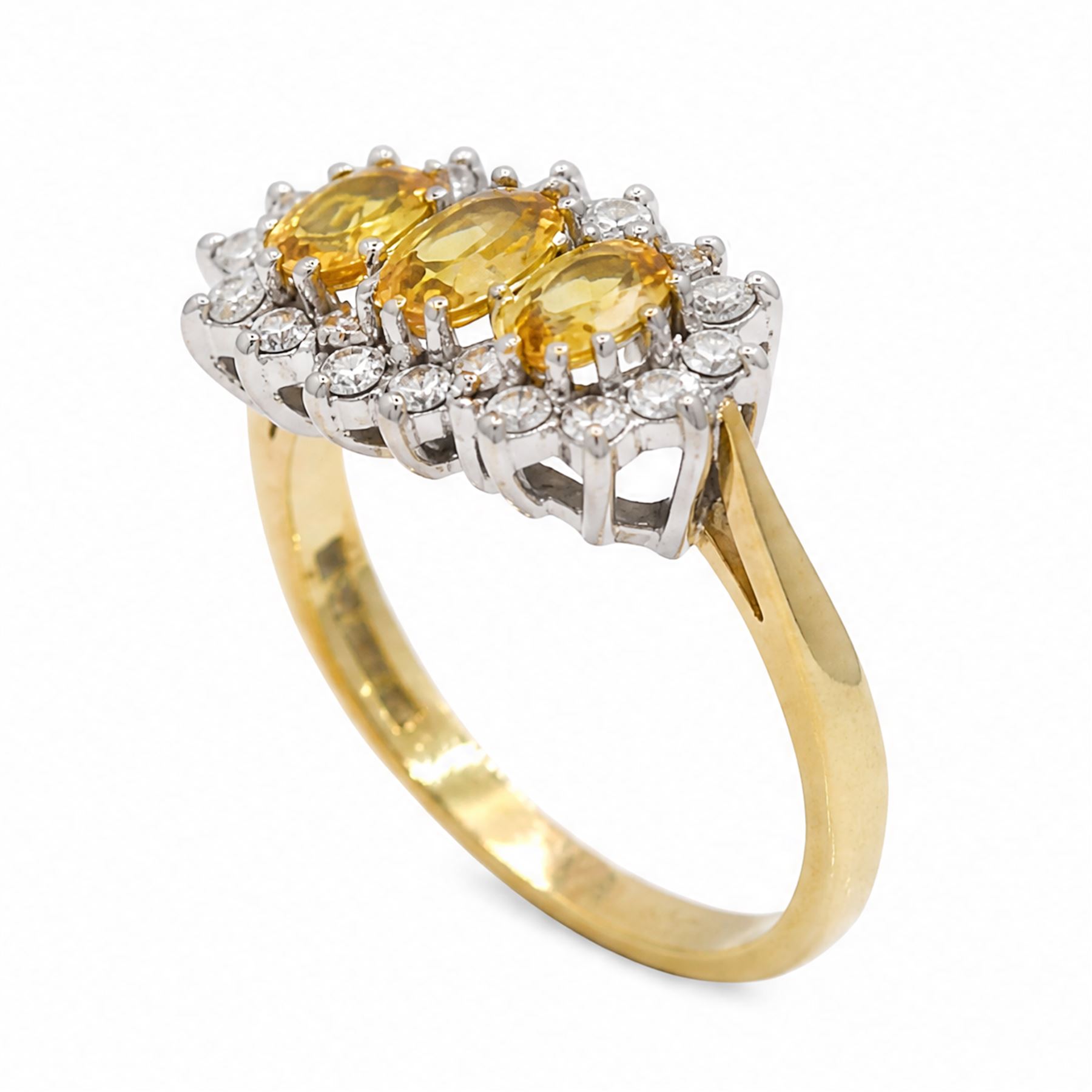 18ct gold yellow sapphire and diamond cluster ring, three oval cut sapphires, surrounded by twenty round brilliant cut diamonds, London 1988, total sapphire weight approx 1.15 carat, total diamond weight approx 0.50 carat