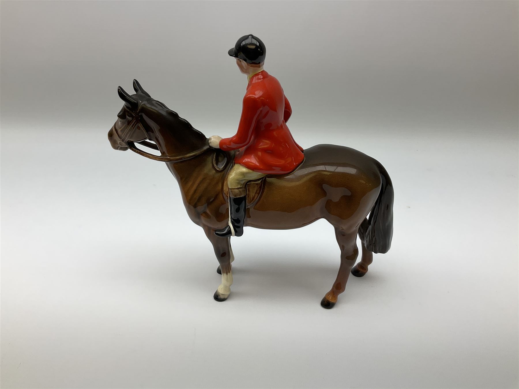 Beswick model of a huntswoman on grey horse model no 1730, and Beswick huntsman on brown horse model no 1501, both with printed mark beneath. 