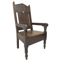 17th century design oak wainscot chair, the back profusely carved with scrolling foliate motifs, the arms carved with repeating guilloche decoration over an arcade apron and turned supports
