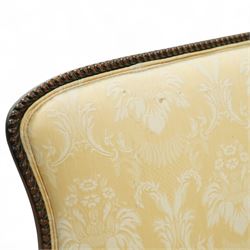 Early 20th century mahogany settee in the George III style, upholstered in pale yellow damask fabric, moulded serpentine seat rail with carved foliate detail, on cabriole supports with acanthus carved knees and scroll feet