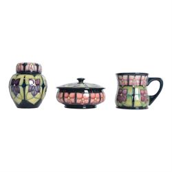 Moorcroft violets pattern ginger jar, together with matching covered dish and mug, all wit...