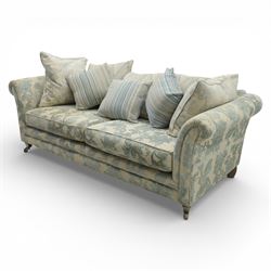 Alstons - 'Lowry' three seater settee, loose cushioned back and seat with additional cushions upholstered in silver and blue floral fabric, supported on square feet with chrome castors to the front