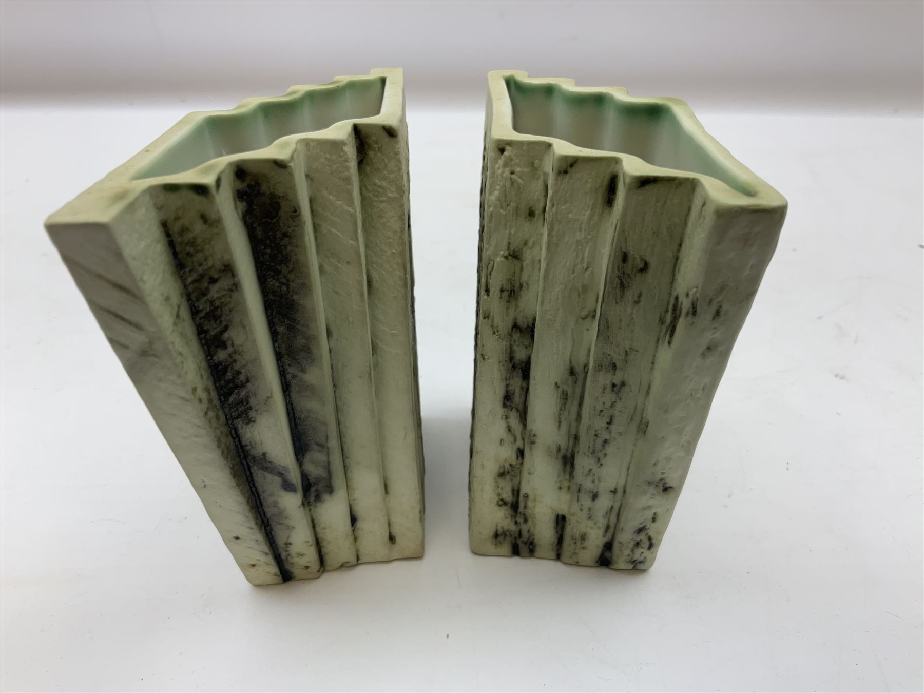 Pair of Carn Pottery Penzance vases of fan form, with tube lined floral and stylised decoration, stamped and marked X9 to base, H11.5cm