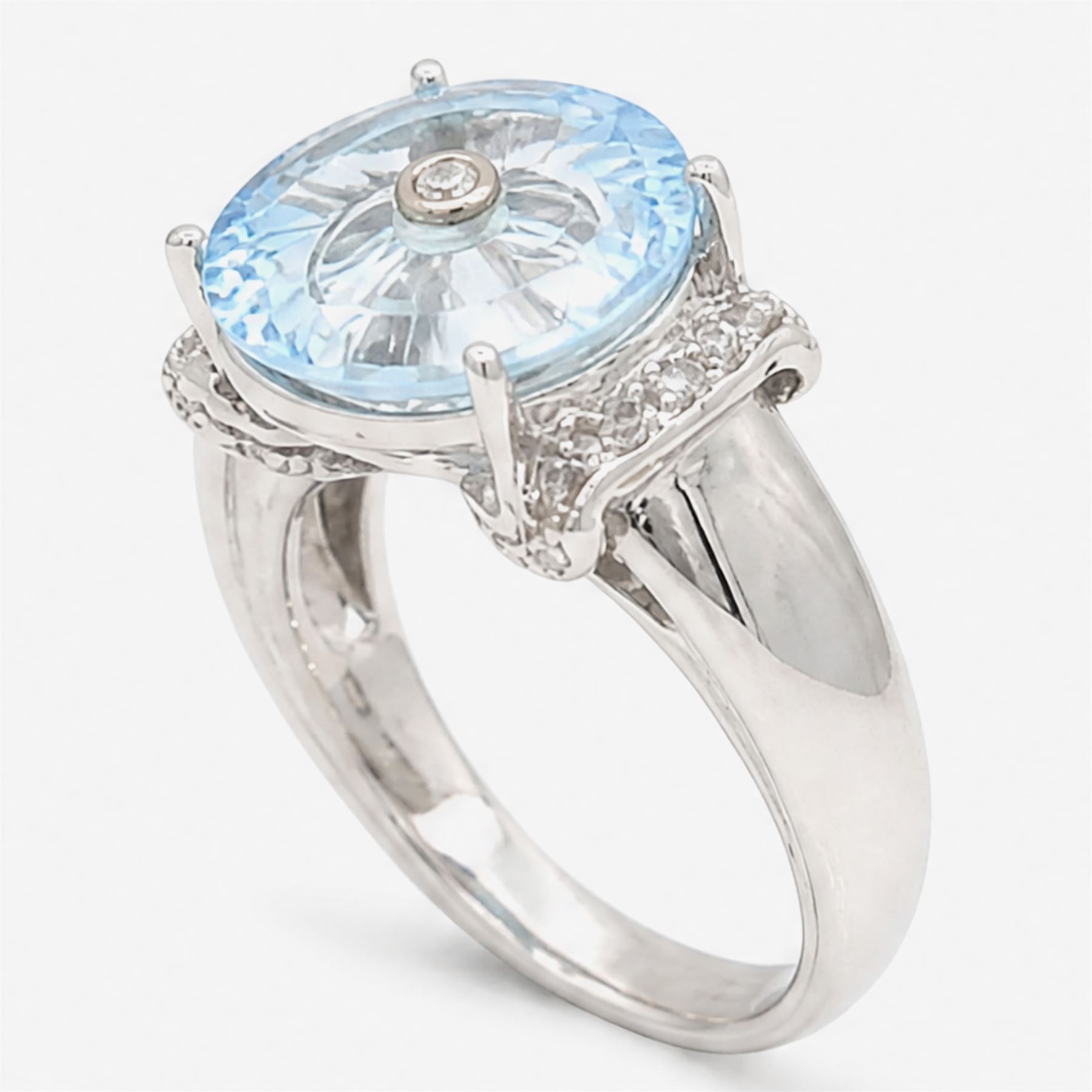 9ct white gold sky blue topaz and diamond Lehrer Torus ring, single round cut topaz of approx 5.20 carat, set with a single round cut diamond, diamond set shoulders and gallery, Birmingham 2012