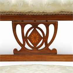 Edwardian mahogany open armchair, the upholstered rectangular back buttoned in ivory patterned fabric within a shaped top rail with inlaid foliate detail, open splat carved with a pierced anthemion motif centred by an inlaid roundel, swept open arms with upholstered pads, over a sprung upholstered seat, on turned front supports with brass castors