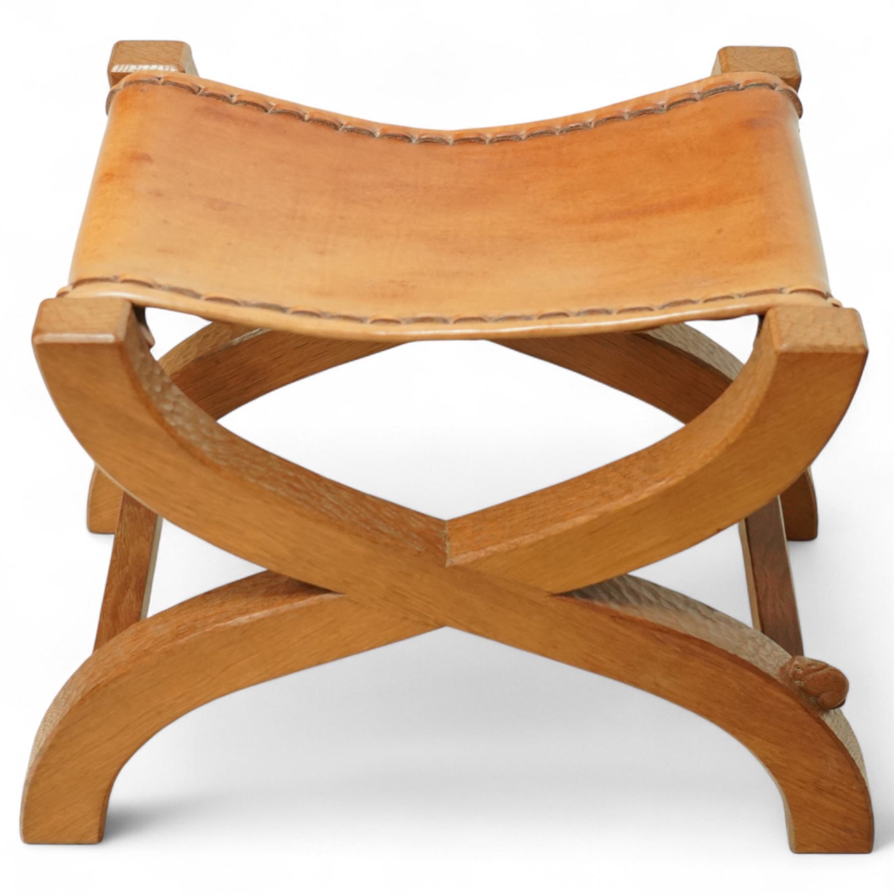 Rabbitman - curved x-framed stool with slung leather seats, adzed throughout the frame with signature Rabbit carving by Peter Heap of Wetwang