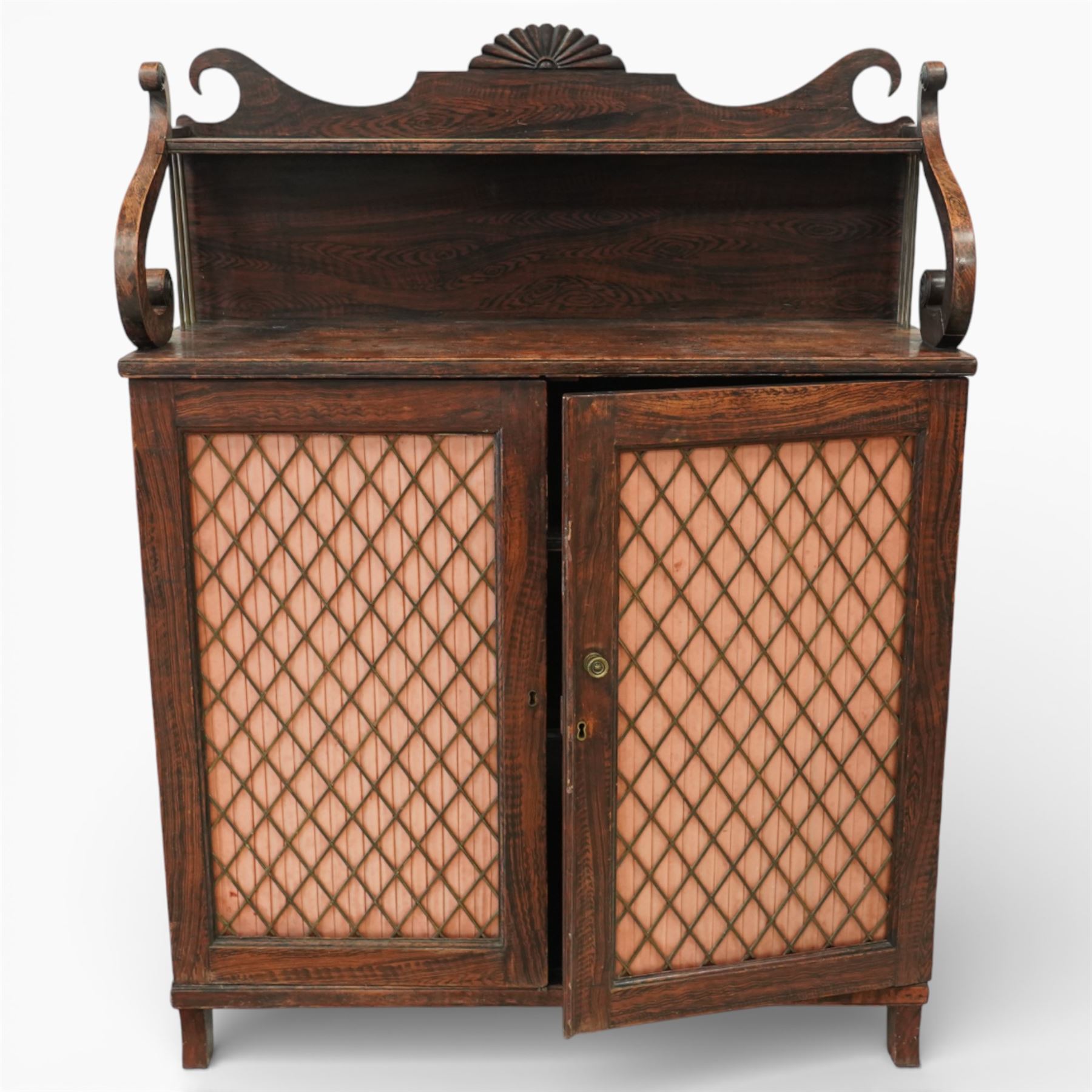 Regency simulated rosewood chiffonier, with shaped scroll supports and shell carved cresting, over a pair of panelled doors inset with diamond lattice glazing, enclosing a shelved interior, raised on short turned feet