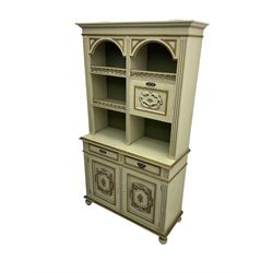Portuguese painted dresser, two-tier plate rack with spindle gallery and fall-front cupboard, flanked by fluted uprights, fitted with two drawers over two cupboards, the panelled cupboards with floral decoration and a rinceaux border, white painted and parcel-gilt 