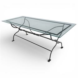 Late 20th century glass dining table, toughened glass top with rounded corners on a wrought metal designed base 