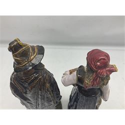 Pair of late 19th century continental glazed stoneware Black Forest style figures, H33cm