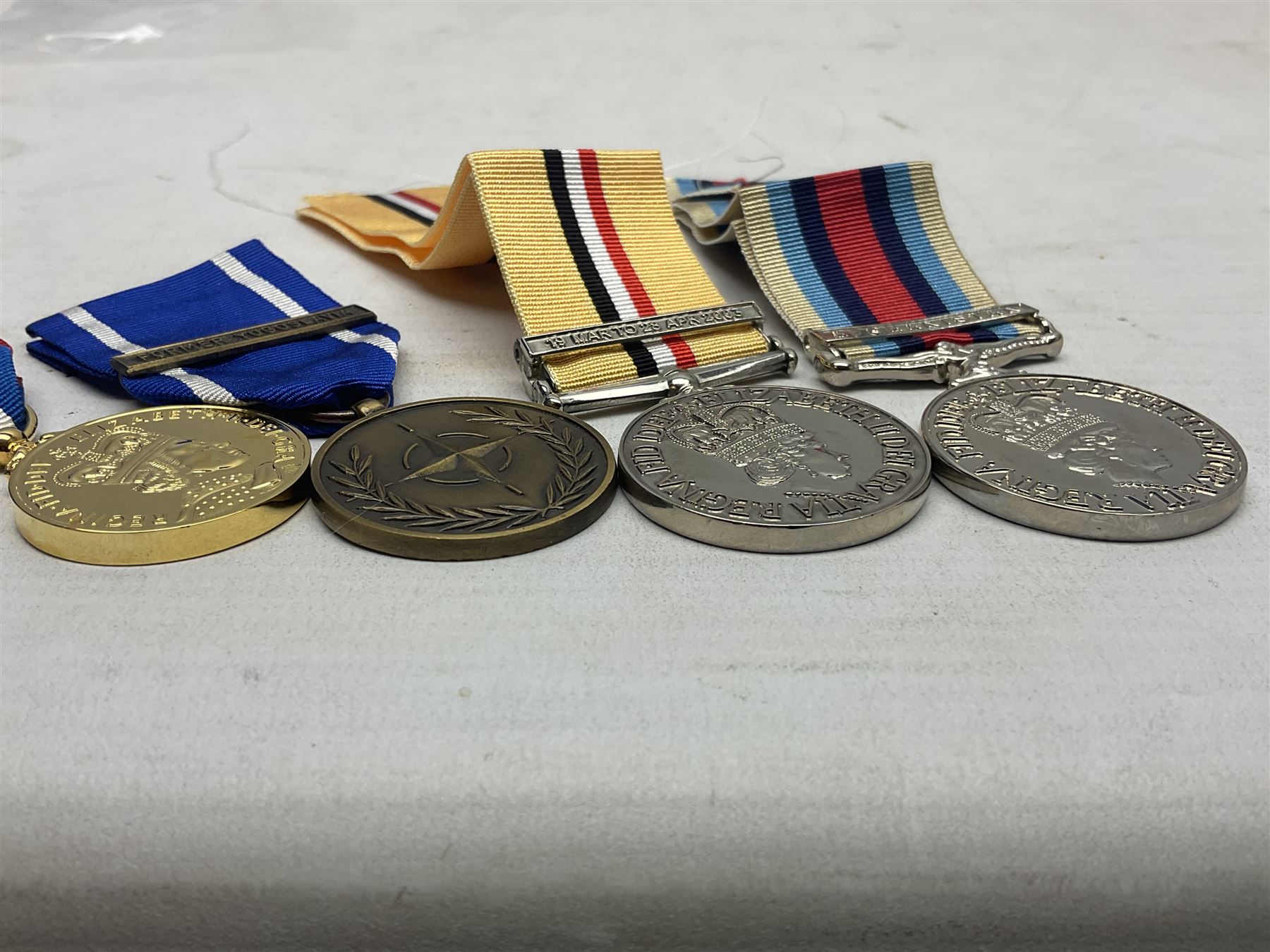NATO Service Medal with clasp for Former Yugoslavia; together with three copy medals - Iraq Medal with clasp for 19 Mar to 28 Apr 2003 and unfitted rosette; Operational Service Medal with Afghanistan clasp; and QEII Golden Jubilee 2002 medal; all with ribbons (4)
