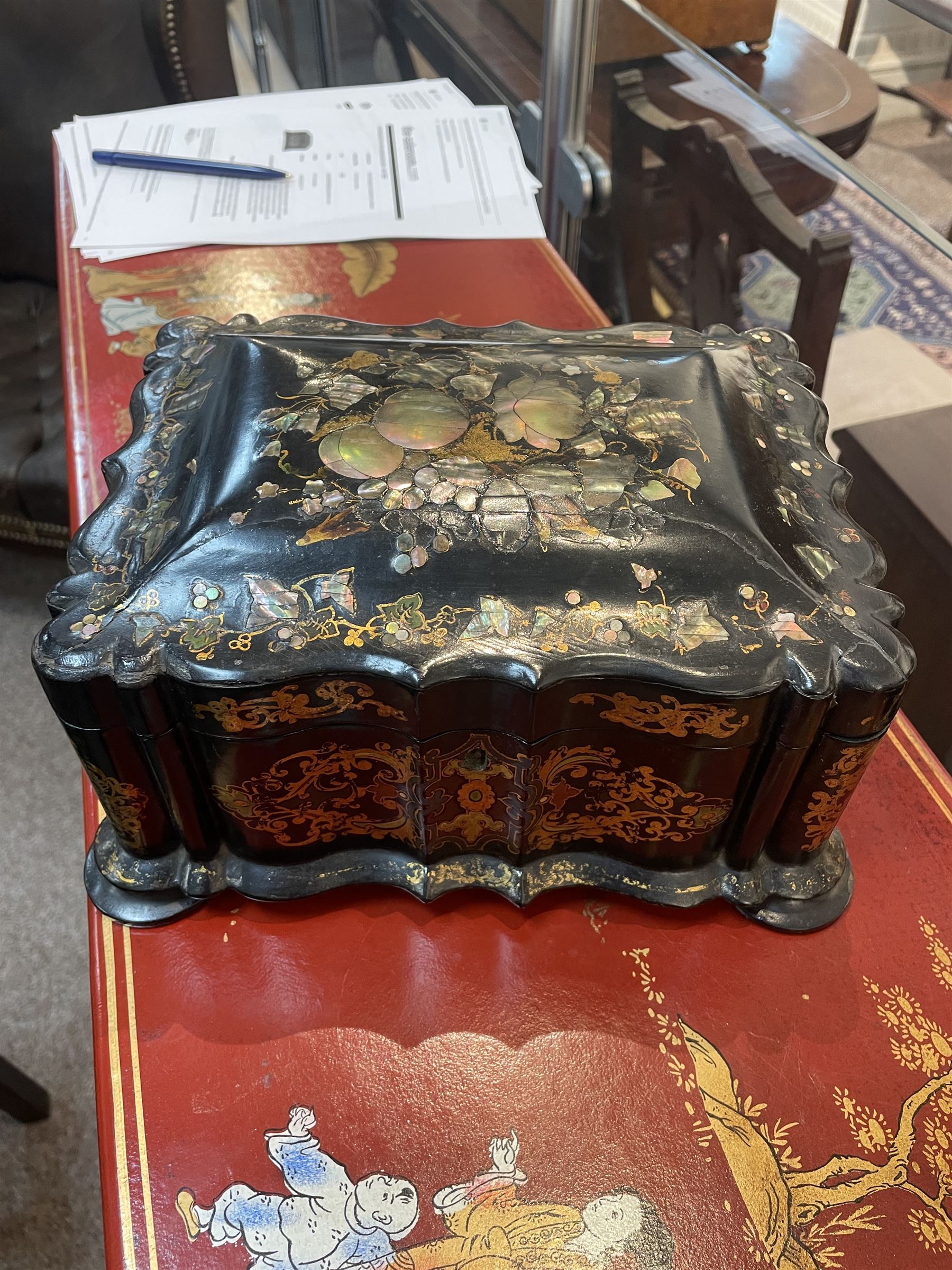 Victorian black lacquered papier-mâché sewing box, of rectangular form with shaped sides, the slightly domed top with inlaid mother of pearl and abalone decoration, the sides with gilt and polychrome painted scrollwork, the hinged cover opening to reveal a fitted interior with lift out tray, H14cm