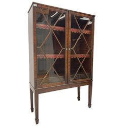 19th century mahogany framed bookcase on stand, fitted with two astragal glazed doors enclosing two shelves over three drawers, raised on square tapering supports with spade feet. This item has been registered for sale under Section 10 of the APHA Ivory Act