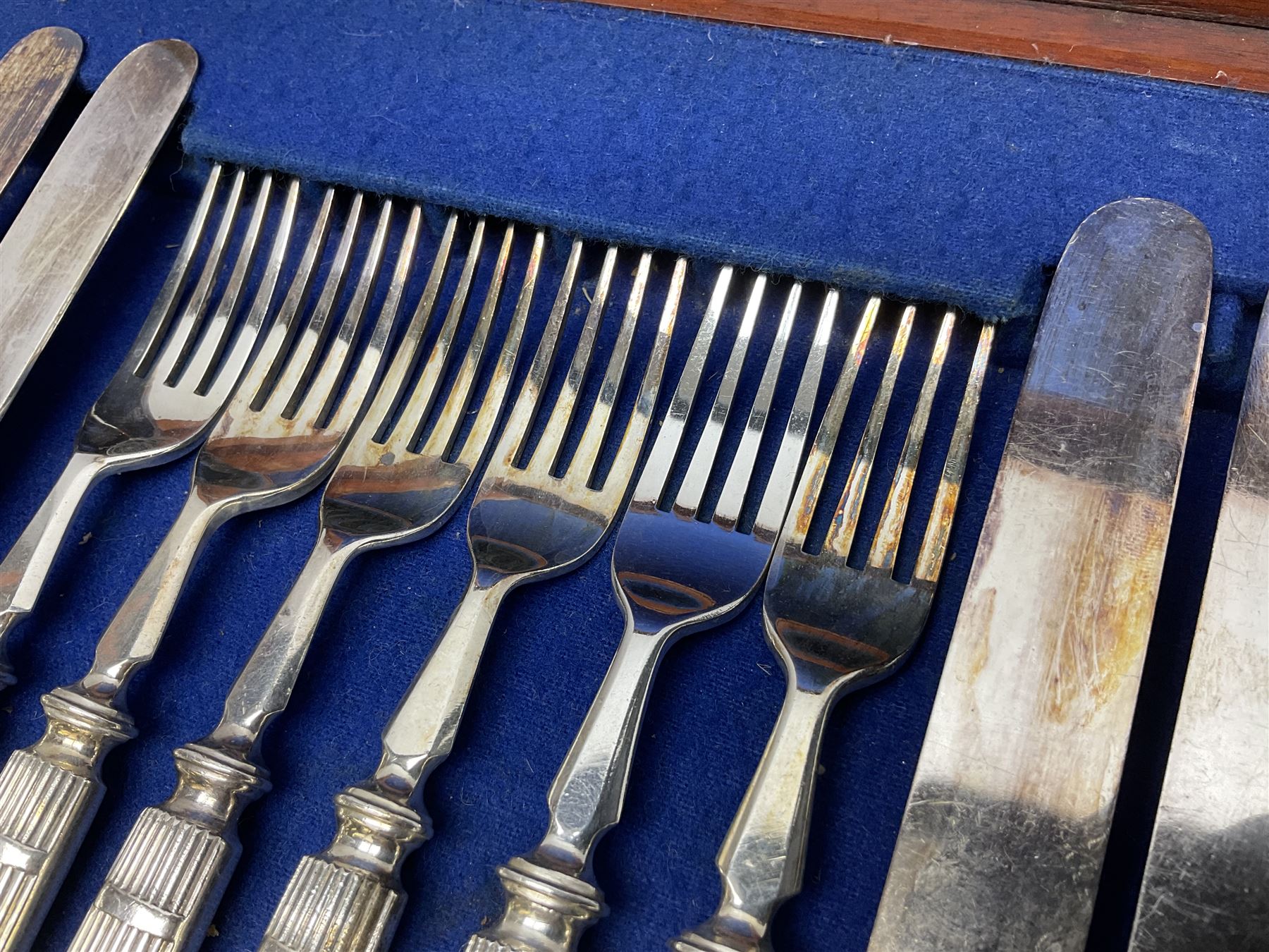 Victorian silver plated dessert set by Elkington & Co for twelve place settings, each reeded handle with vacant cartouche, each with Elkington & Co mark, date letter for 1861, and registration lozenge, contained within a mahogany case with vacant brass cartouche to the hinged cover, opening to reveal a Royal blue baize lined interior with removable tray, case H6cm W29.5cm D26.5cm