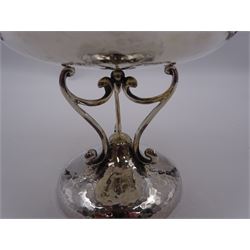 Early 20th century Arts & Crafts silver tazza, the circular planished bowl supported by three curved supports upon a circular spreading planished base, hallmarked Walker & Hall, Sheffield 1909