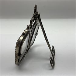 Early 19th century silver plated double photograph frame, each rounded rectangular aperture surrounded by a paste border, with ornate scroll feet and mantling also set with clear paste stones, with easel style support verso, H12cm