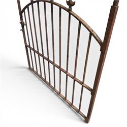 Georgian wrought iron single garden gate, pointed finial over strapwork cresting rail and arched profile with spearhead finials, the opposing side with scrollwork and hinged latch