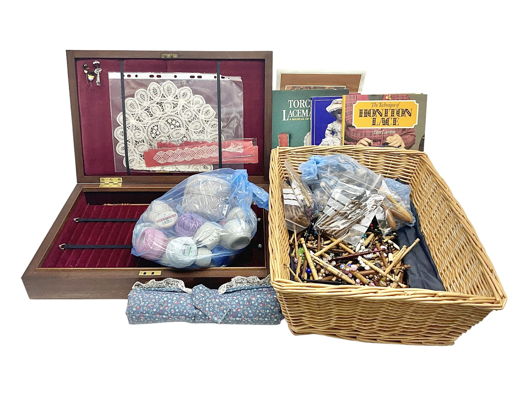 Collection of lace making wooden bobbins, together with lace making books and a handmade storage box