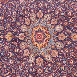North West Persian carpet, the indigo field centred by a lobed medallion in pale blue and ochre with floral pendants, profusely decorated with scrolling foliage, palmettes and flowerheads, ivory floral spandrels, enclosed by a red ground palmette border and multiple floral guard bands