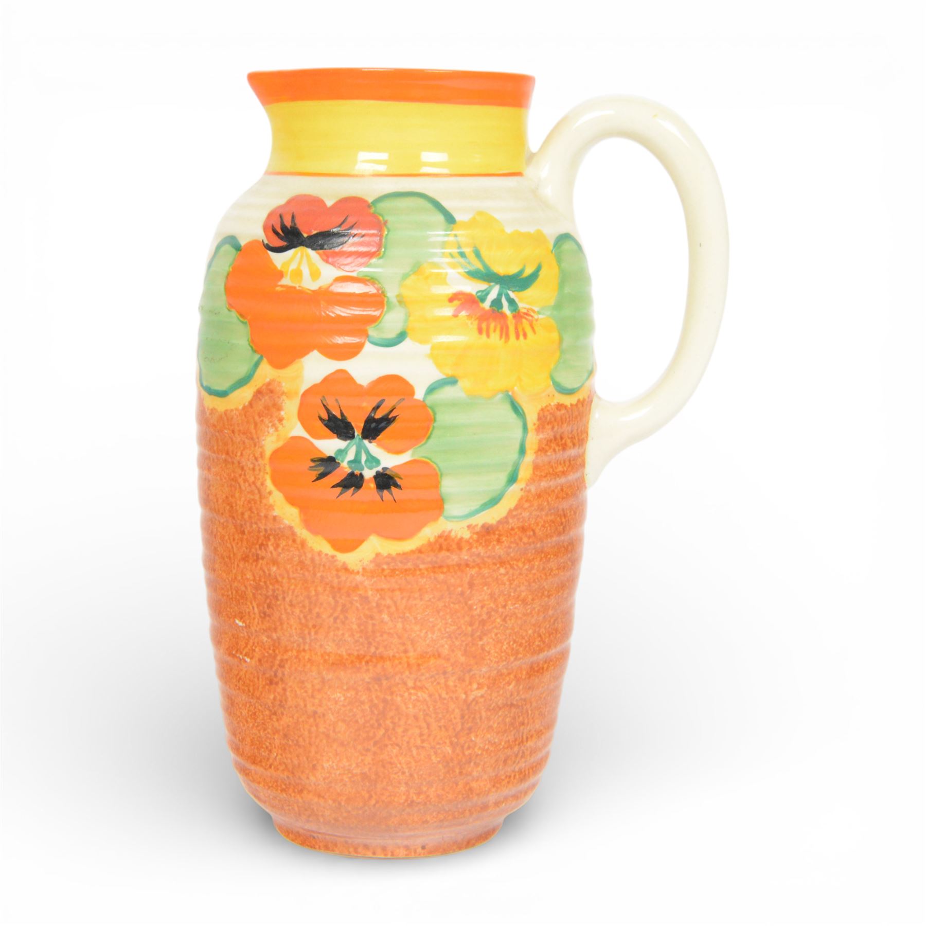 Clarice Cliff Nasturtium jug, shape Greek 563, hand painted with a band of stylised flowers and foliage over a stippled brown ground with orange and yellow banding to the spout,  Bizarre mark beneath, H23cm