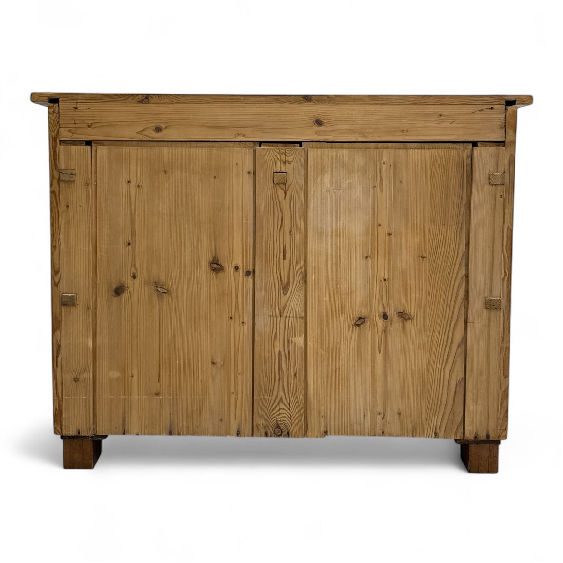19th century pine chest of drawers, rectangular top over two short and two long drawers with oval pressed brass backplates and drop handles, panelled sides, rounded front edges, on compressed bun feet