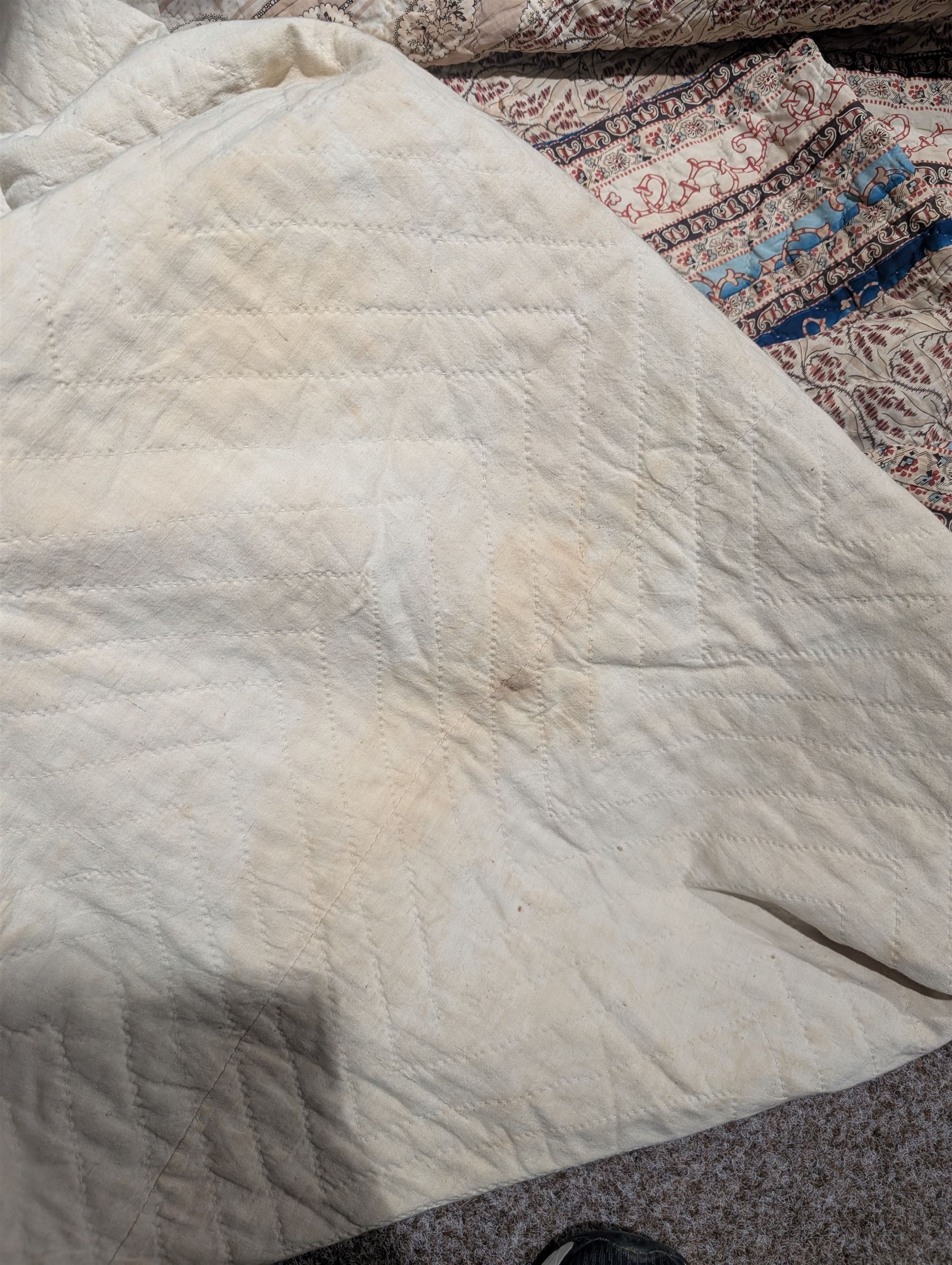 Handmade large patchwork quilt bedspread made up of individual squares of multi-coloured cottons and backed in a cream cotton, 243cm x 284cm 