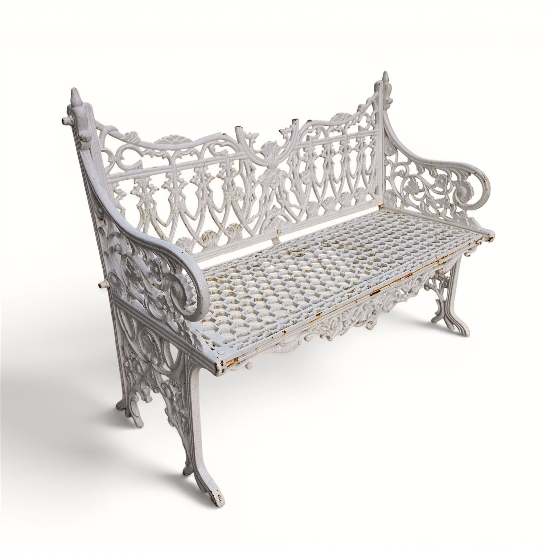 Victorian revival heavy cast iron garden bench, ornate back rest with scrolls, floral motifs and central crest, pierced lattice seat, curved arms and decorative legs, painted in antique white, in the Gothic Coalbrookdale style - Damaged 