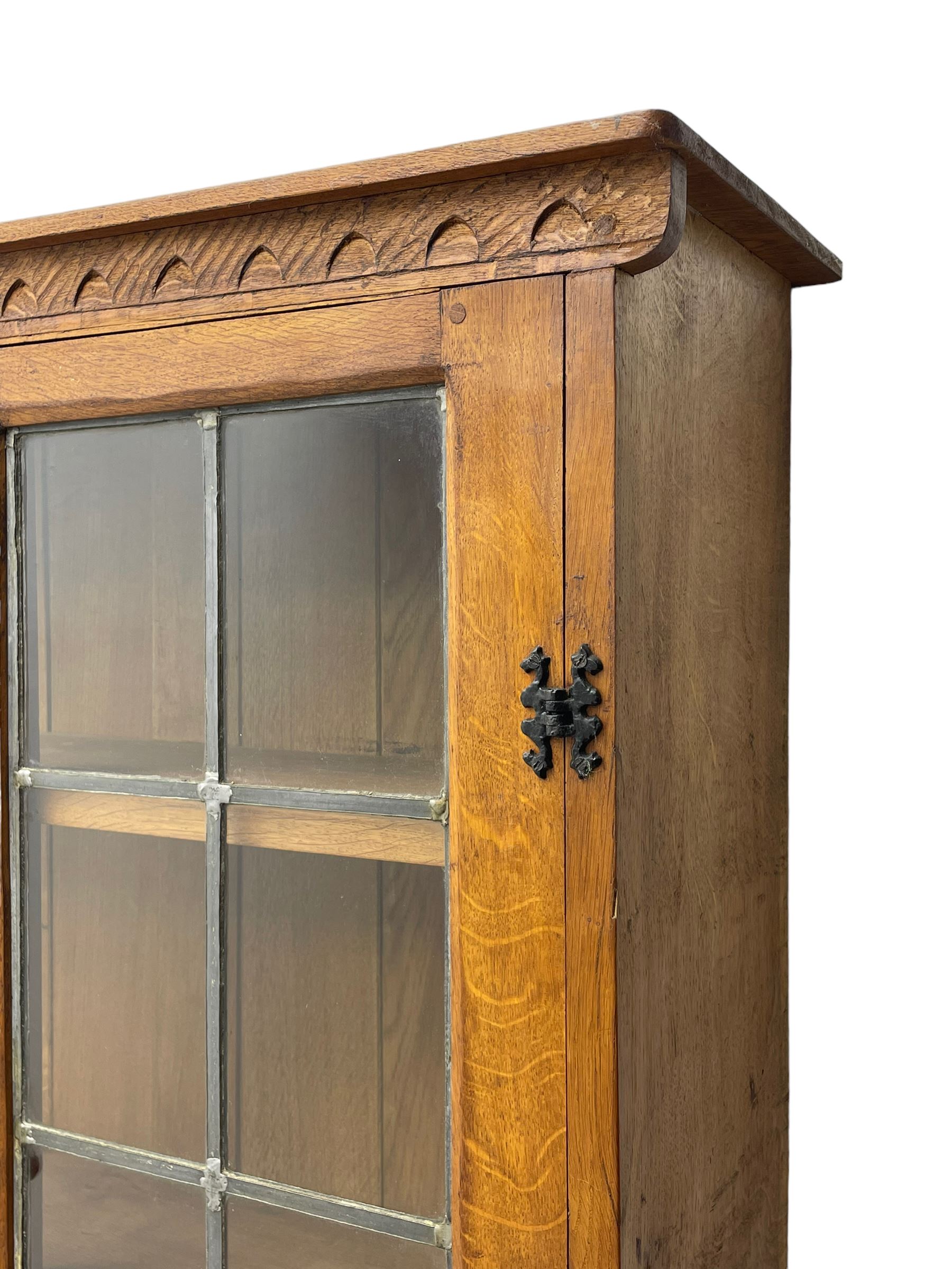 Gnomeman - adzed oak dresser, arcade carved cresting rail over two lead glazed doors, double cupboard below enclosed by two panelled doors, carved with gnome signature, by Thomas Whittaker, Little Beck 