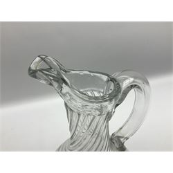 Early 19th century Continental soda glass jug, the wrythen bulbous body with thick rim and lip and hollow curved handle, upon a circular foot, H28.5cm
